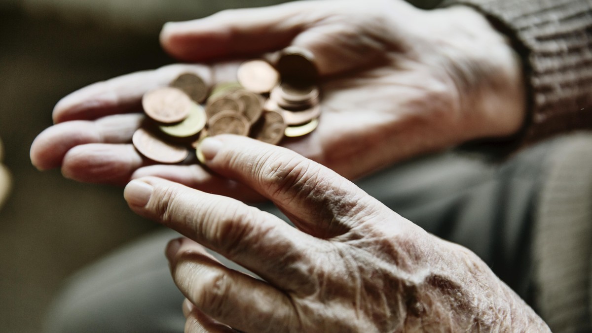 Senior woman's hands with coins