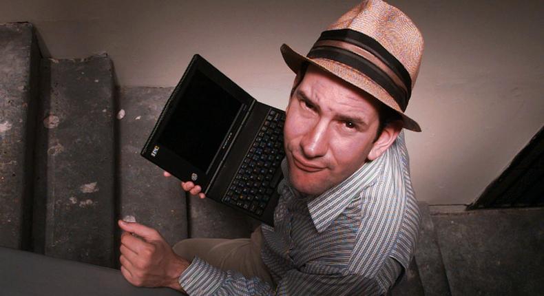 Matt Drudge carries a laptop computer as he walks up the stairs at his Hollywood-area apartment in Los Angeles June 18, 1997.