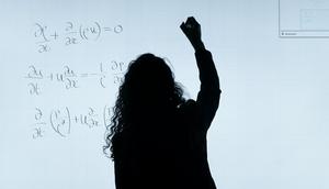 Woman writing on a whiteboard [Image Credit: ThisIsEngineering]