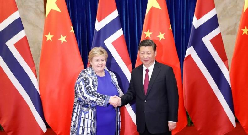 Chinese President Xi Jinping shakes hands with Norway's Prime Minister Erna Solberg at the Great Hall of People in Beijing on April 10, 2017