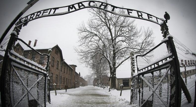 A group of seven men and four women -- Poles, Belarussians and one German -- carried out the unprecedented stunt in front of Auschwitz's infamous Arbeit macht frei gate, where they draped a white banner with love written in red