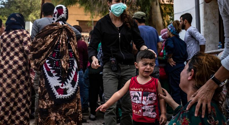 A woman and a child react as the body of a man killed during Turkish shelling in the area surrounding the Syrian Kurdish town of Ras al-Ain arrives at a hospital in the nearby town of Tal Tamr following the announced ceasefire on October 18, 2019. - Turkish-led bombardment on October 18 killed over a dozen civilians in northeastern Syria, as Turkey's president threatened to broaden his assault and an hours-old US-brokered deal already appeared to crumble. That deal was meant to provide a five-day pause for the evacuation of Kurdish fighters from the battleground border town of Ras al-Ain and other areas Turkey wants to control along its border with Syria. (Photo by Delil SOULEIMAN / AFP) (Photo by DELIL SOULEIMAN/AFP via Getty Images)