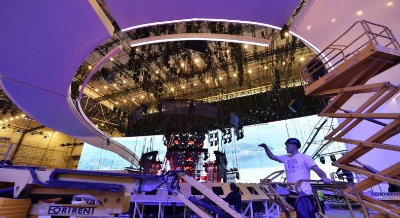 Workers install stage lighting at the International Exhibition Center in Kiev on April 11, 2017 during the preparations for the Eurovision Song Contest 2017 to be held in the Ukrainian capital from May 9 to 13