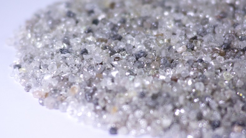 A heap of rough diamonds on a white background. [Photo by Waldo Swiegers/Bloomberg]