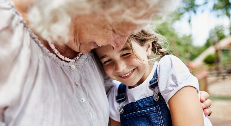 A grandmother embraces her granddaughter.Oliver Rossi/Getty images