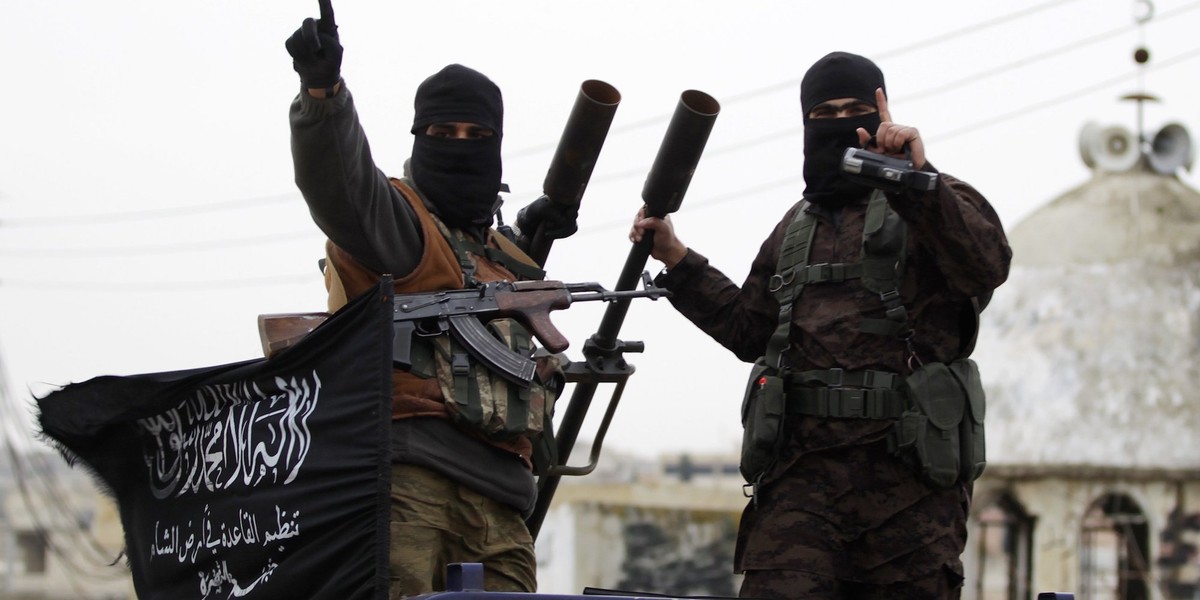 Members of Al Qaeda's Nusra Front in a convoy touring villages, which they said they have seized control of from Syrian rebel factions, in the southern countryside of Idlib, on December 2, 2014.