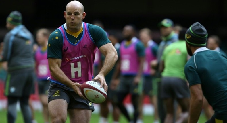 Australia's hooker Stephen Moore passes the ball as Australian players train at the Principality stadium in Cardiff on November 4, 2016 on the eve of their international match against Wales