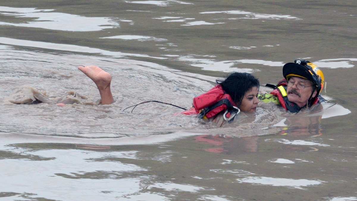 San Marcos Firefighter Jay Horton rescues a woman from in flood waters in San Marcos Texas