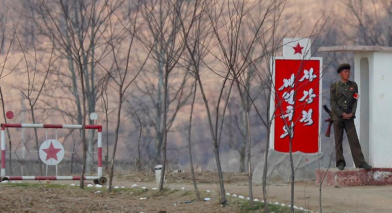 A North Korean soldier guards the gate on banks of the Yalu River, north of Sinuiju, North Korea.
