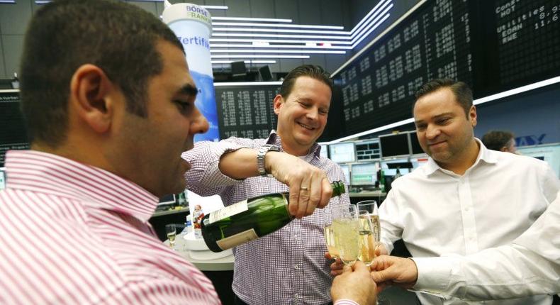 Bourse traders pour champagne after the last trading day at Frankfurt's stock exchange