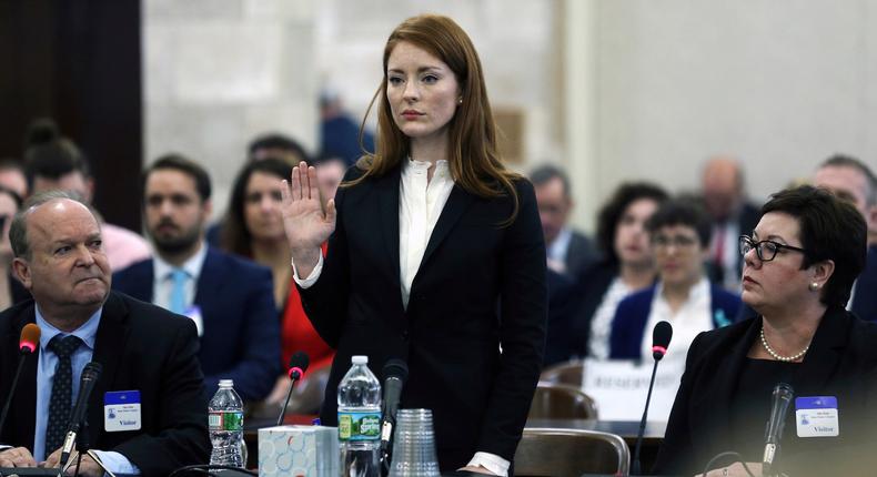 Katie Brennan, the chief of staff at the New Jersey Housing and Mortgage Finance Agency, raises her hand as she is sworn-in to testify before the Select Oversight Committee at the Statehouse on December 4.