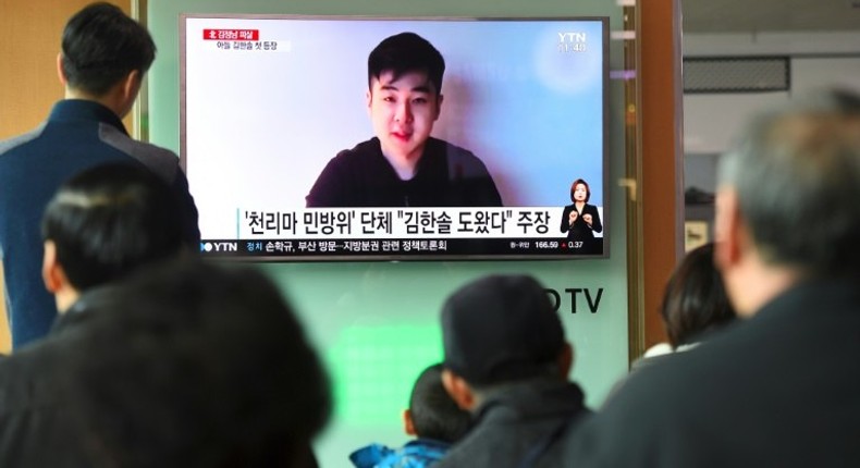 South Koreans watch a TV broadcast showing video footage of a man who claims to be Kim Han-Sol, a nephew of North Korea's leader Kim Jong-Un, at a railway station in Seoul, on March 8, 2017