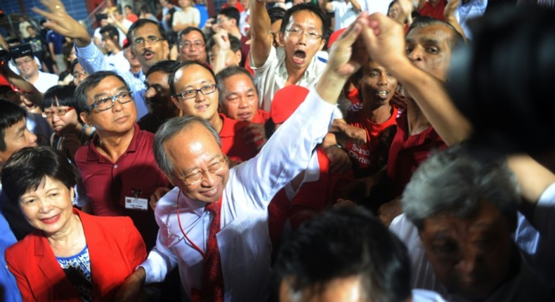 Singaporean presidential candidate Tan Cheng Bock (2nd-L) greeting his supporters in 2011 when he stood as candidate of the presidential elections in Singapore