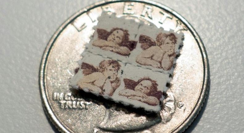 LSD blotter tabs on a US quarter coin, used as part of an illegal and potentially risky trend, of taking tiny amounts of psychedelic drugs too boost work or treat ailments