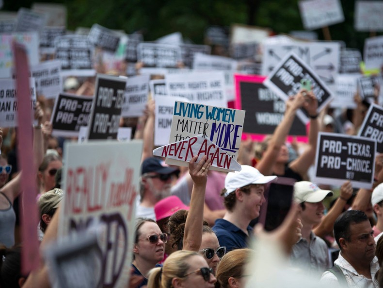 Protesters holding up signs during a Texas rally for abortion rights in Houston on May 7.