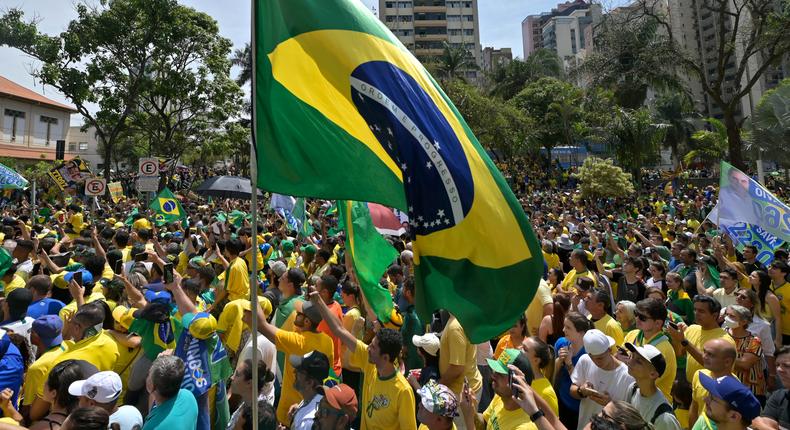 Supporters of Brazil's President Jair Bolsonaro wave a Brazilian flag during a 2022 campaign rally.