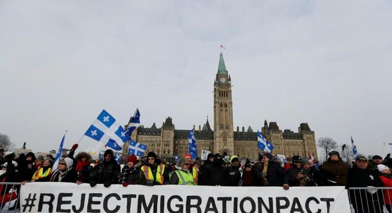 Right-wing protesters rally against the UN international pact on migration at Parliament Hill in Ottawa