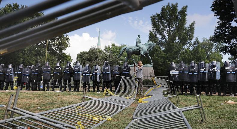 Virginia State Police in riot gear stand in front of the statue of General Robert E. Lee before forcing white nationalists, neo-Nazis and members of the 'alt-right' out of Emancipation Park after the 'Unite the Right' rally was declared an unlawful gathering August 12, 2017 in Charlottesville, Virginia.