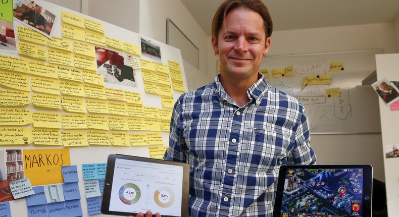 Dave Bruno, head of the innovation lab at Swiss bank UBS, poses with two tablet computers in his office in Zurich.