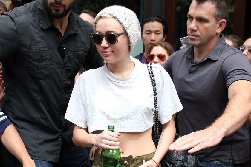 Miley Cyrus w grubej czapce i z odsłoniętym brzuchem