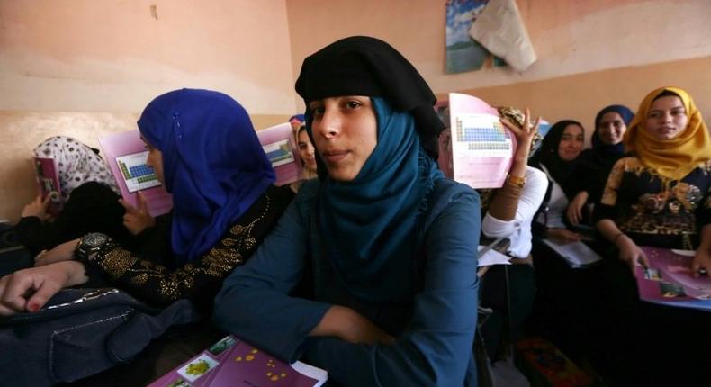 Iraqi girls attend a class at a school in western Mosul on July 27, 2017