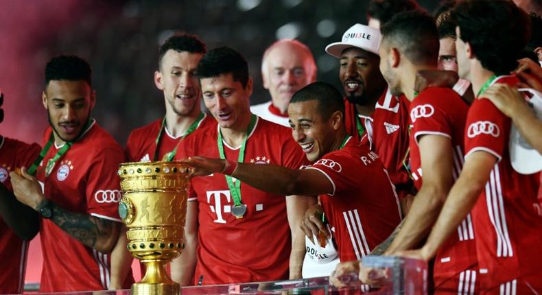 Thiago Alcantara touches the German Cup trophy after Bayern Munich's 4-2 triump over Bayer Levekursen in Saturday's German Cup final.