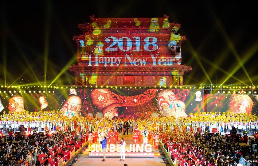 People celebrate the new year during a countdown event at Yongdingmen Gate in Beijing