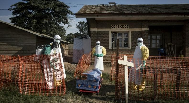 Medical workers disinfect the coffin of a deceased unconfirmed Ebola patient inside an Ebola Treatment Centre run by The Alliance for International Medical Action (ALIMA) in Beni; DR Congo's health ministry has said a new outbreak has claimed 170 lives