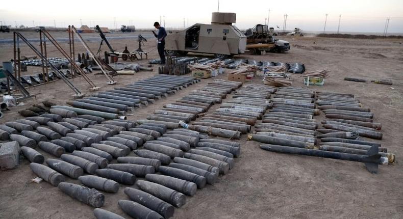 Ammunition, a homemade armoured car and mortars launchers confiscated from Islamic State group jihadists are displayed on the ground in the town of Qaraqosh, 30 kms east of Mosul, after Iraqi forces recaptured it from the group