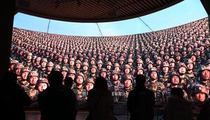 People watch a video about China's military advancements at the Military Museum in Beijing on March 3, 2024.GREG BAKER/AFP via Getty Images