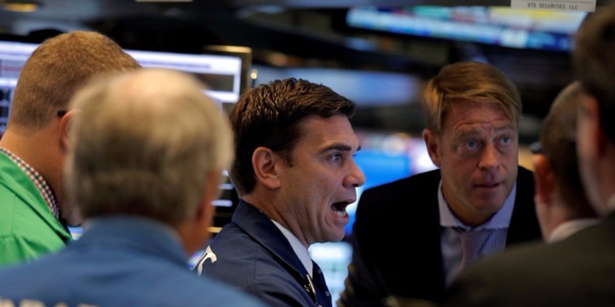 Traders work on the floor of the NYSE