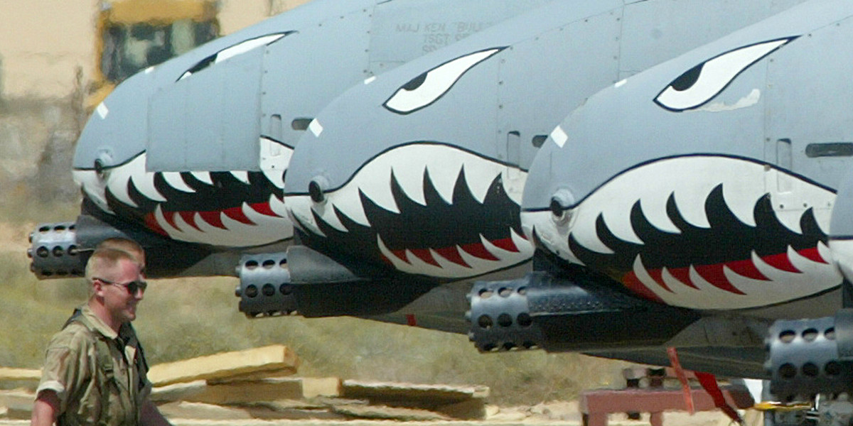 A US ground crew member walks past a line of American A-10s on an airbase in Kuwait on March 16, 2003.