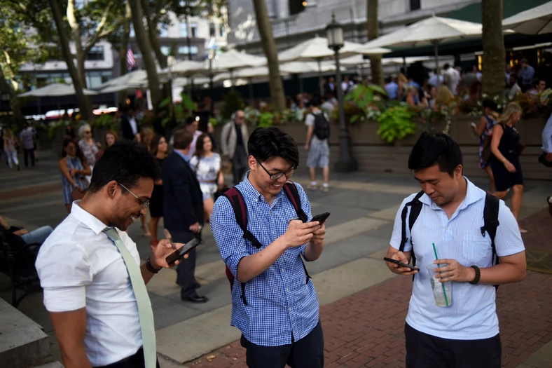 People play the augmented reality mobile game "Pokemon Go" by Nintendo in New York City