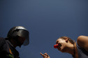 A picketer speaks to a riot policeman at the entrance to the Corte Ingles department store during a nationwide general strike in Malaga