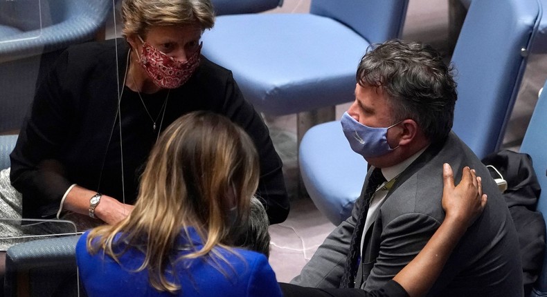 US Ambassador to the UN Linda Thomas-Greenfield (partially hidden) comforts Ukraine Permanent Representative to the United Nations Sergiy Kyslytsya.