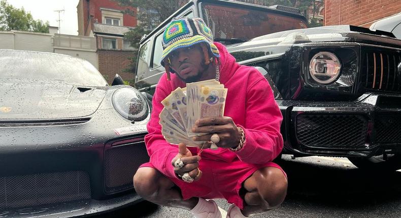Tanzanian superstar Diamond Platnumz shows off cash on the streets of London, UK