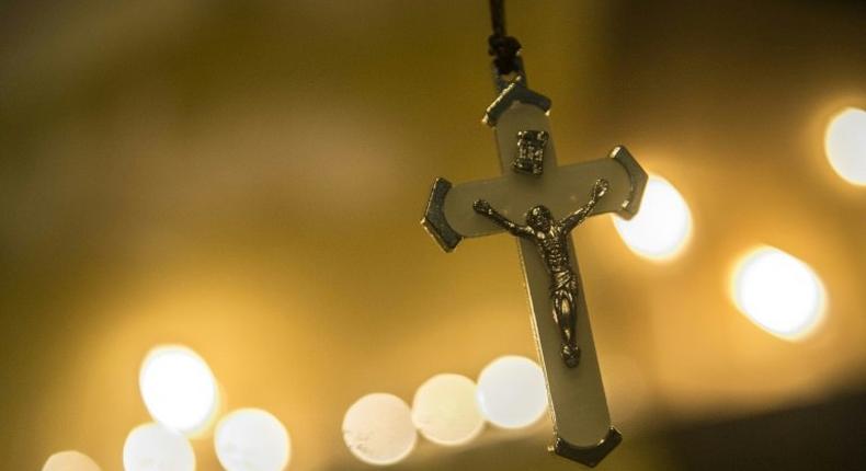 Egyptians attend a candlelight vigil outside the Saint Peter and Saint Paul Coptic church in Cairo on December 17, 2016