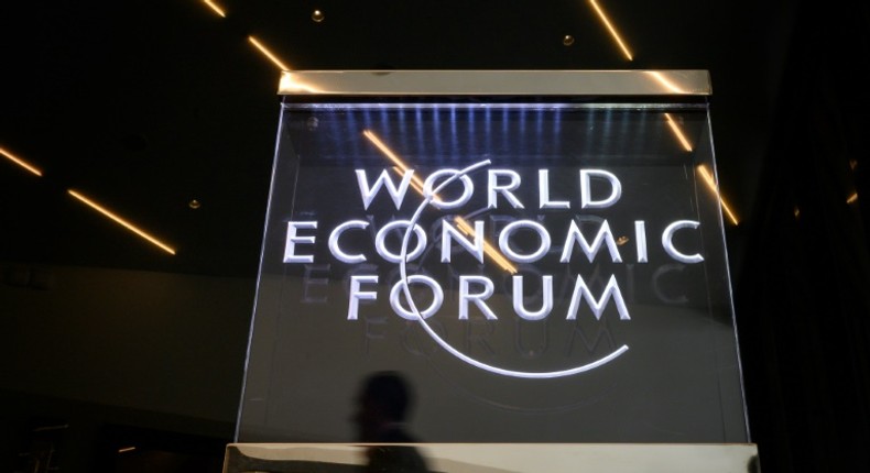 A man walks past a sign of the World Economic Forum (WEF) at the Congress Centre in Davos, eastern Switzerland