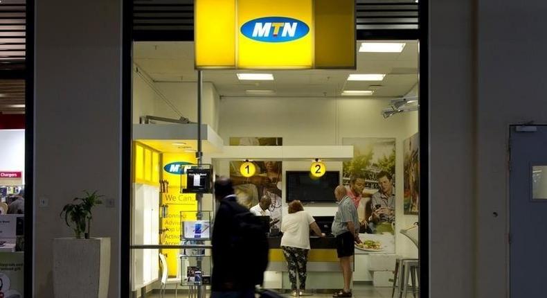 Travellers walk past an MTN telecom shop at King Shaka International Airport in Durban, South Africa, November 16, 2015. REUTERS/Rogan Ward