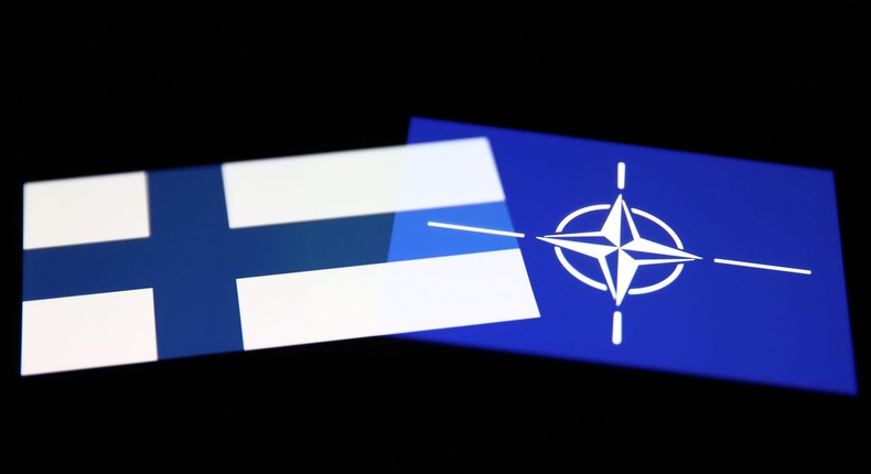 Flags of Finland and NATO are seen displayed on phone screens in this multiple exposure illustration photo taken in Krakow, Poland on May 12, 2022.