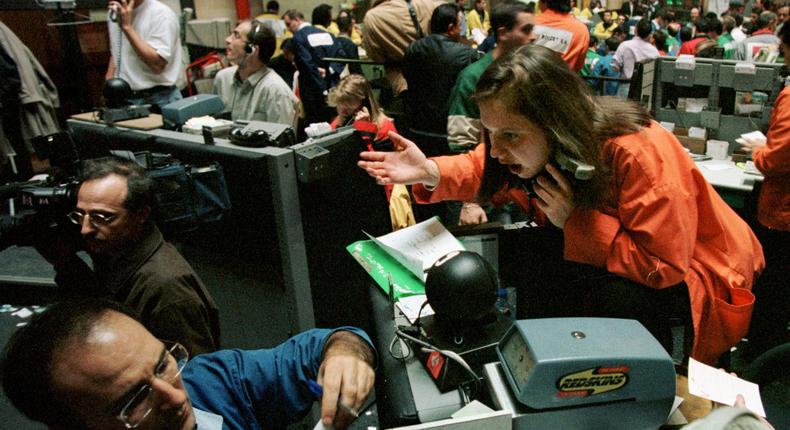 A trader ignores an animated colleague, much in the way Wall Street strategists are ignoring stock market history.