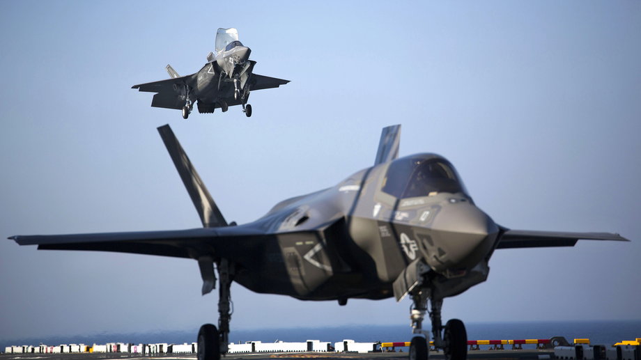 Two US Marine F-35B Lightning II Joint Strike Fighters complete vertical landings aboard the USS Wasp (LHD-1) during operational testing May 18, 2015.
