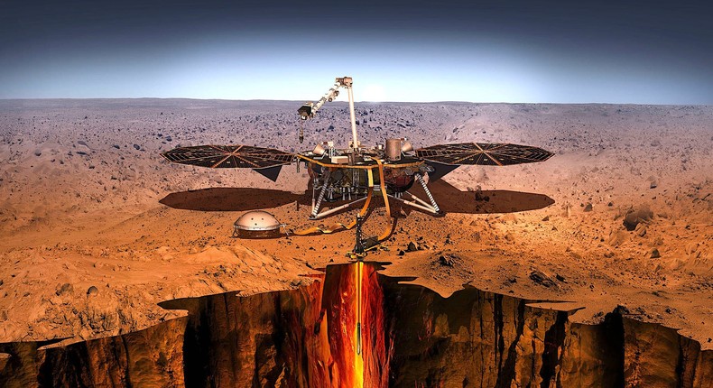 An artist illustration of the InSight lander on Mars, with its mole burrowed deep in the soil.