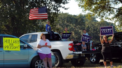 Supporters of U.S. Republican presidential nominee Donald Trump wait outside a campaign rally with U