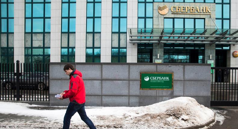 A person walks by Sberbank HQ in downtown Moscow