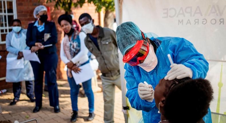 Doctors Without Borders nurse Bhelekazi Mdlalose performs a COVID-19 test on a health worker in Johannesburg, South Africa on May 13, 2020.
