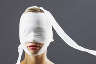 Bandage covering woman's face