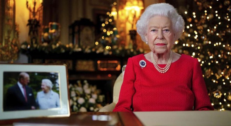 The Queen with a framed photo of herself and the late Duke of Edinburgh looking at each other fondly at their diamond wedding anniversary in 2007.