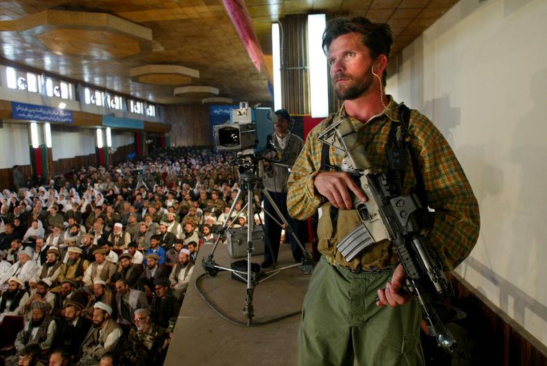 A SEAL Team 6 close-protection operator at an event with Afghan President Hamid Karzai.
