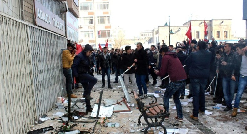 People protest in front of the offices of pro-Kurdish Peoples' Democratic Party following a suicide car bombing on December 17, 2016 in Kayseri